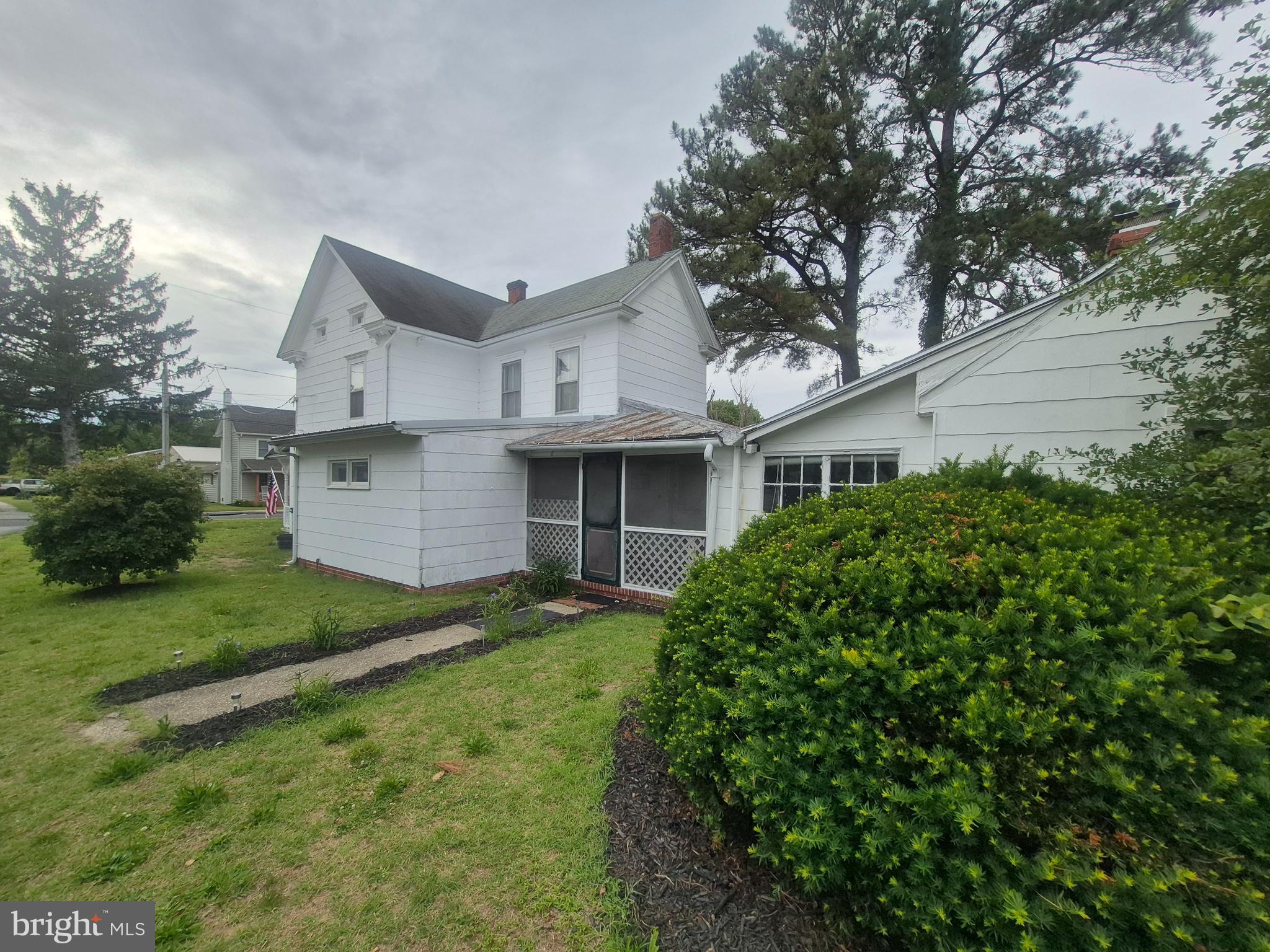 715 Main Street Sharptown, MD 21861 - Photo 23 of 36 a front view of a house with a yard and garage