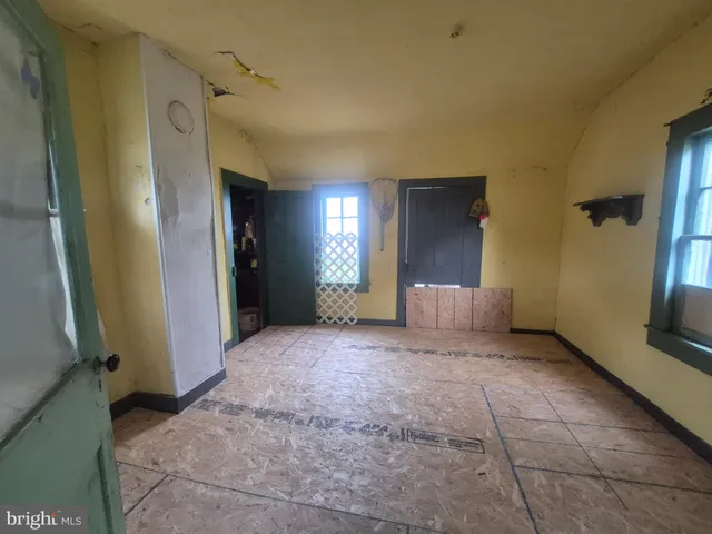 a view of a hallway with closet and window