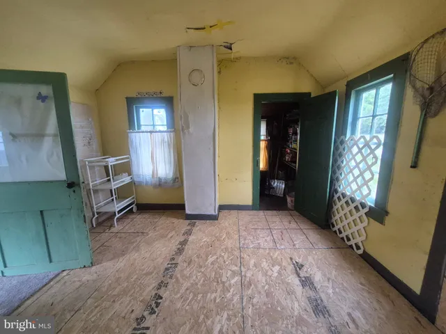 an entryway and livingroom with furniture