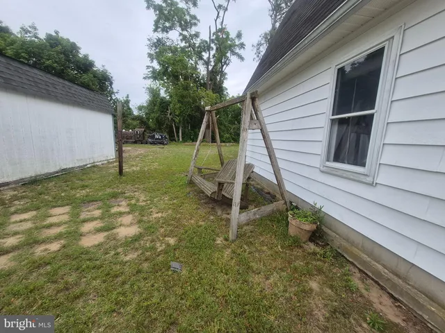 a view of a backyard with a wooden fence