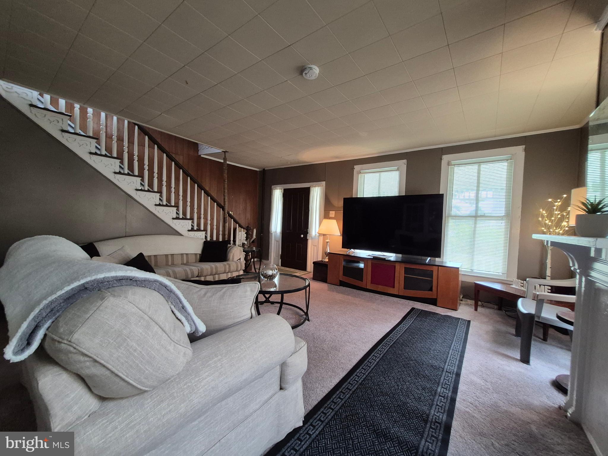 715 Main Street Sharptown, MD 21861 - Photo 4 of 36 a living room with furniture and a flat screen tv