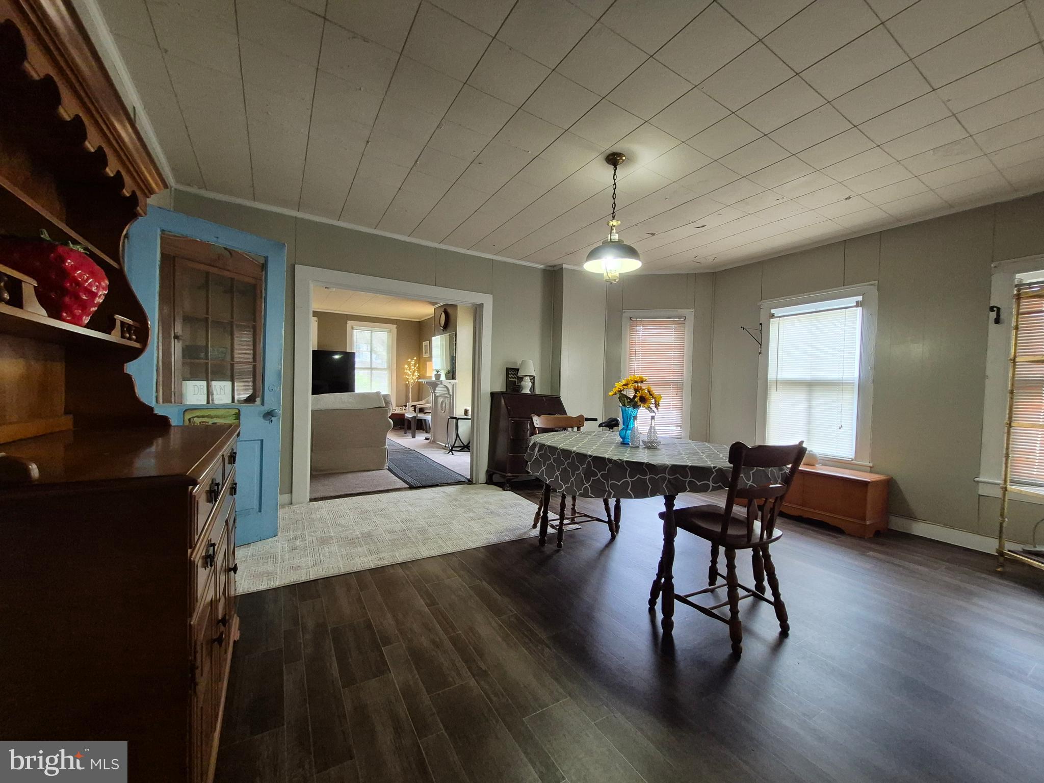 715 Main Street Sharptown, MD 21861 - Photo 10 of 36 a living room with furniture and a dining table with wooden floor