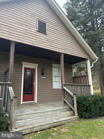 a view of a house with a balcony and stairs