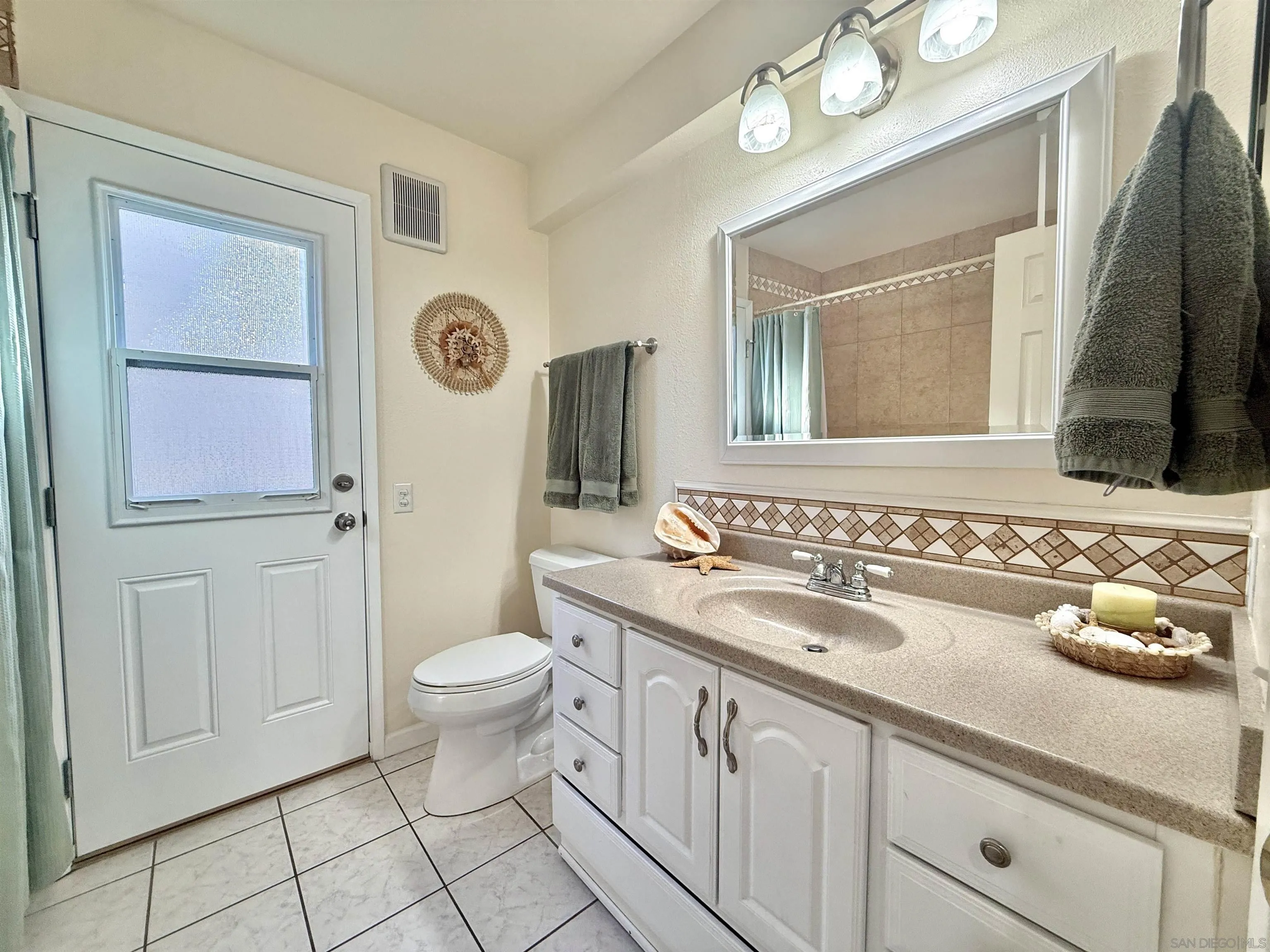 2049 Wind River Road El Cajon, CA 92019 - Photo 13 of 29 a bathroom with a sink a toilet and mirror