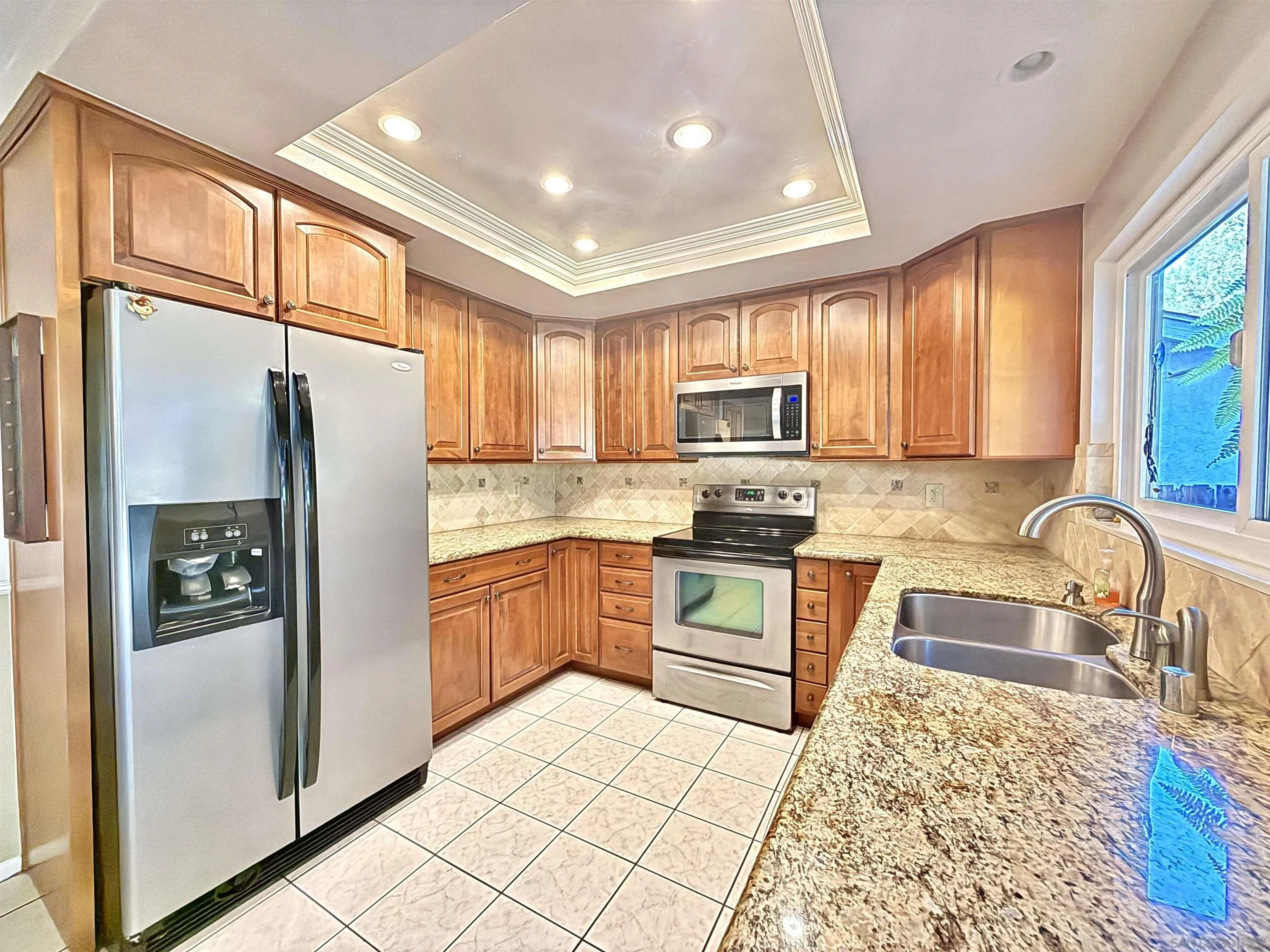 2049 Wind River Road El Cajon, CA 92019 - Photo 6 of 29 a kitchen with granite countertop a refrigerator stove top oven and sink
