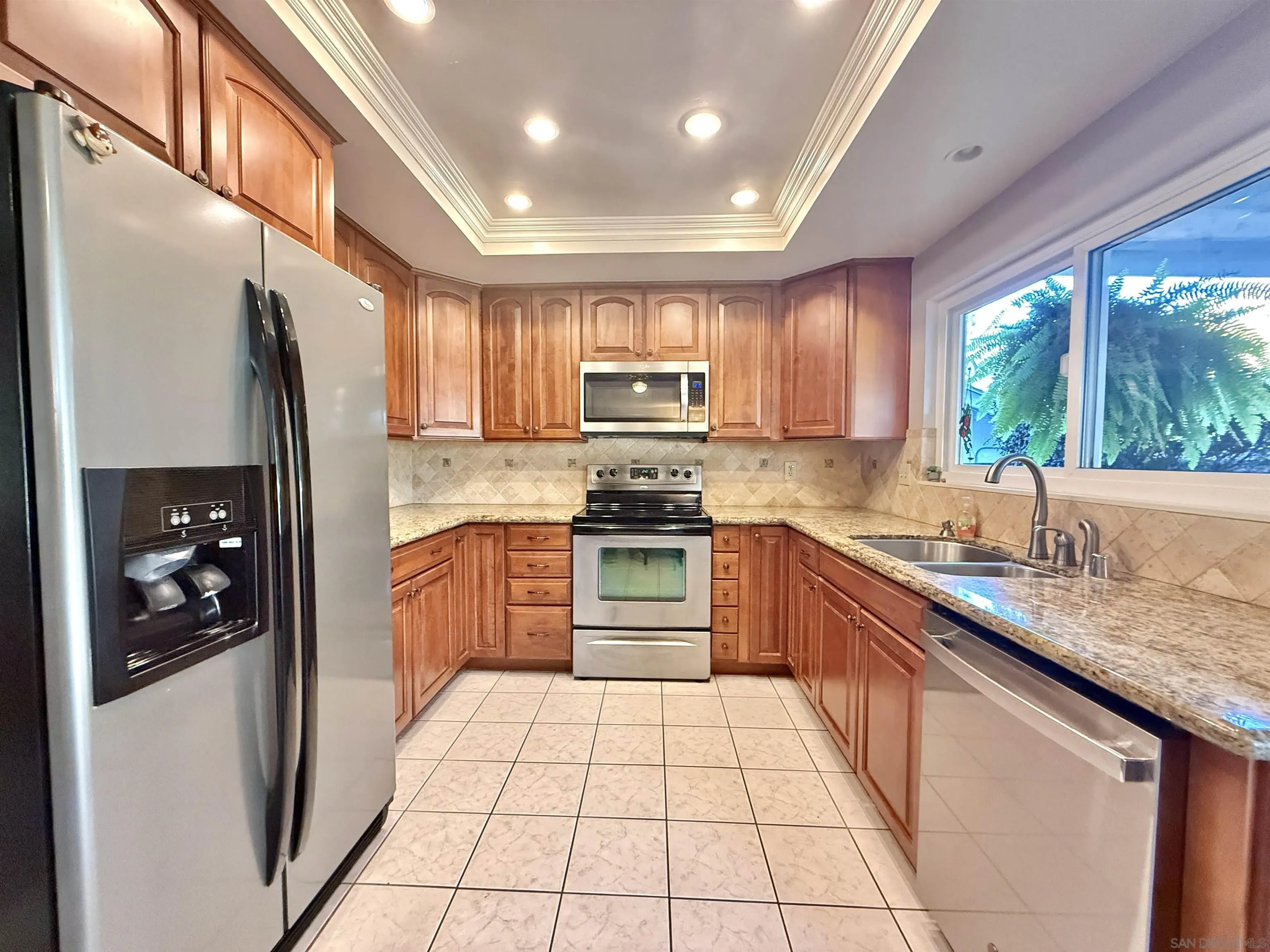 2049 Wind River Road El Cajon, CA 92019 - Photo 8 of 29 a kitchen with stainless steel appliances granite countertop a refrigerator and a sink