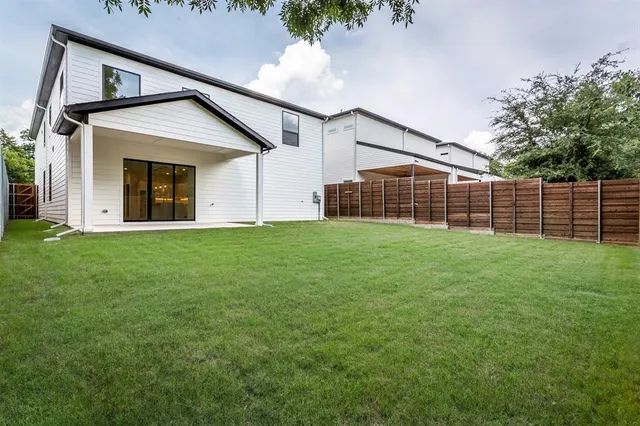 a view of a house with a yard and sitting area