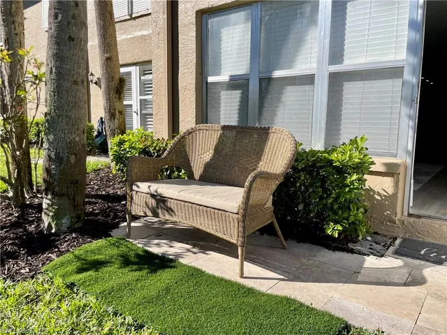 a view of a house with backyard sitting area and garden