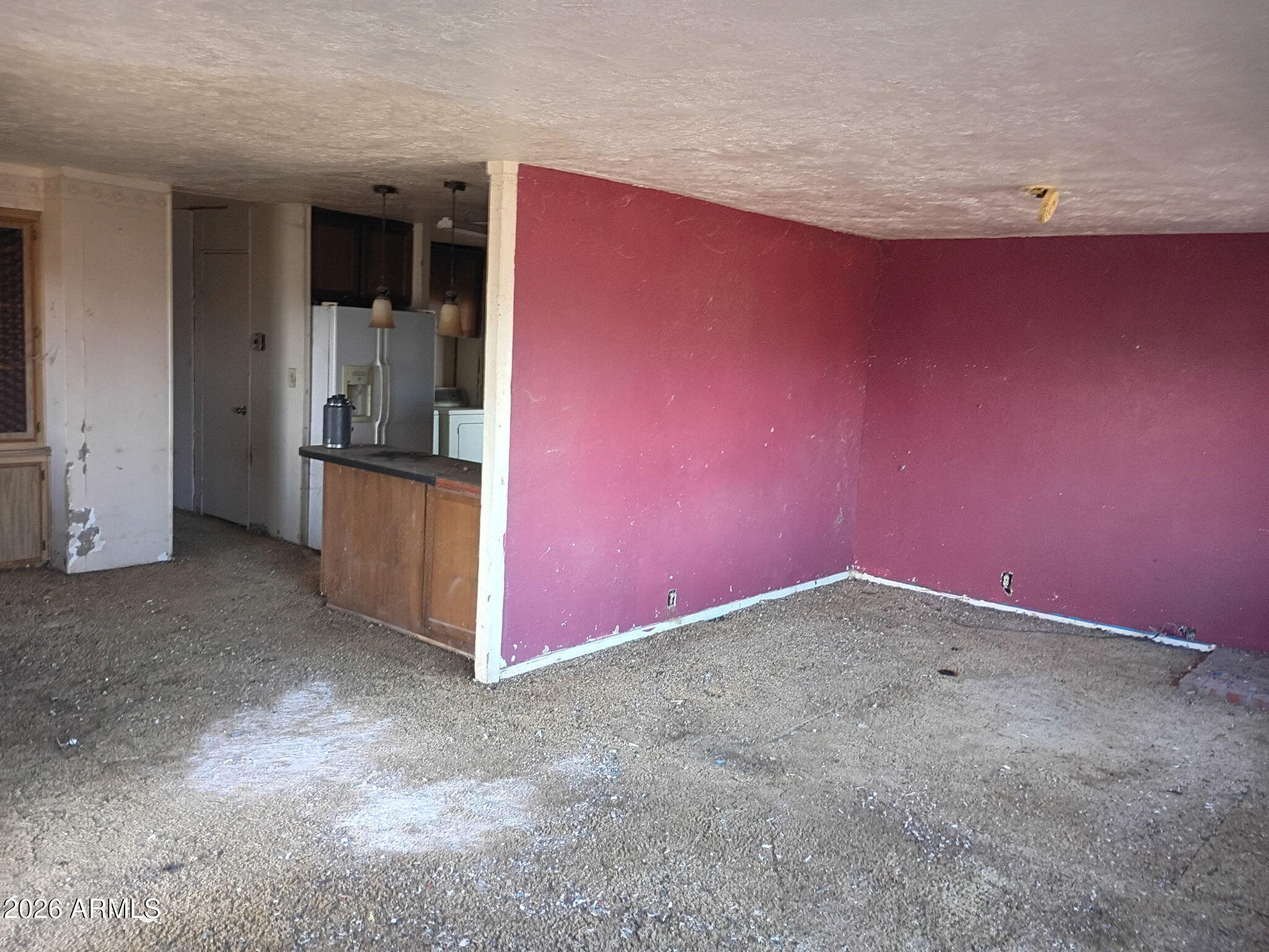 6826 North Rock House Road McNeal, AZ 85617 - Photo 12 of 13 an empty room with a refrigerator