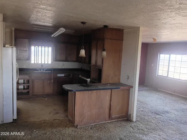 a kitchen with a stove and a refrigerator