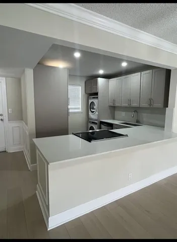 a kitchen with a sink a stove and cabinets