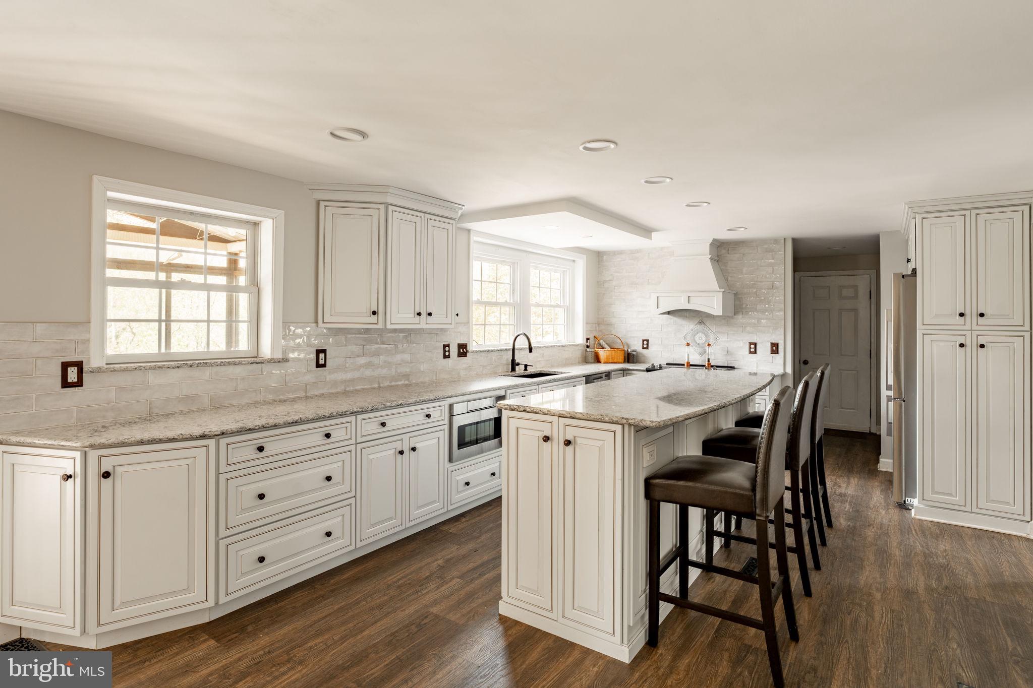 2072 Spring Valley Road Lansdale, PA 19446 - Photo 3 of 48 a kitchen with white cabinets chair and sink