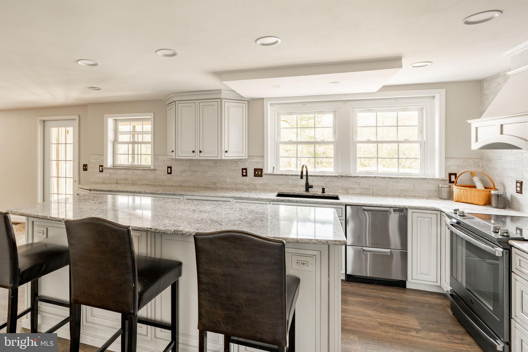 2072 Spring Valley Road Lansdale, PA 19446 - Photo 7 of 48 a kitchen with a stove a sink and chairs