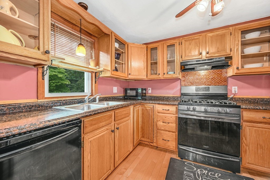45 Boston Road, Unit C Sutton, MA 01590 - Photo 15 of 35 a kitchen with stainless steel appliances granite countertop a stove and a sink