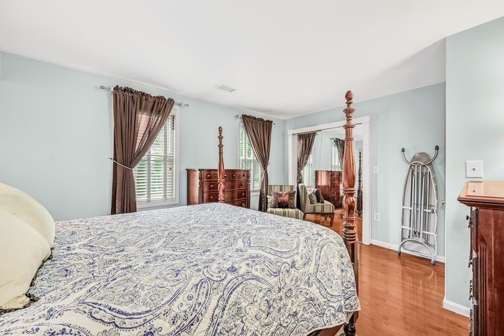 45 Boston Road, Unit C Sutton, MA 01590 - Photo 19 of 35 a bedroom with a large bed and a wooden floor