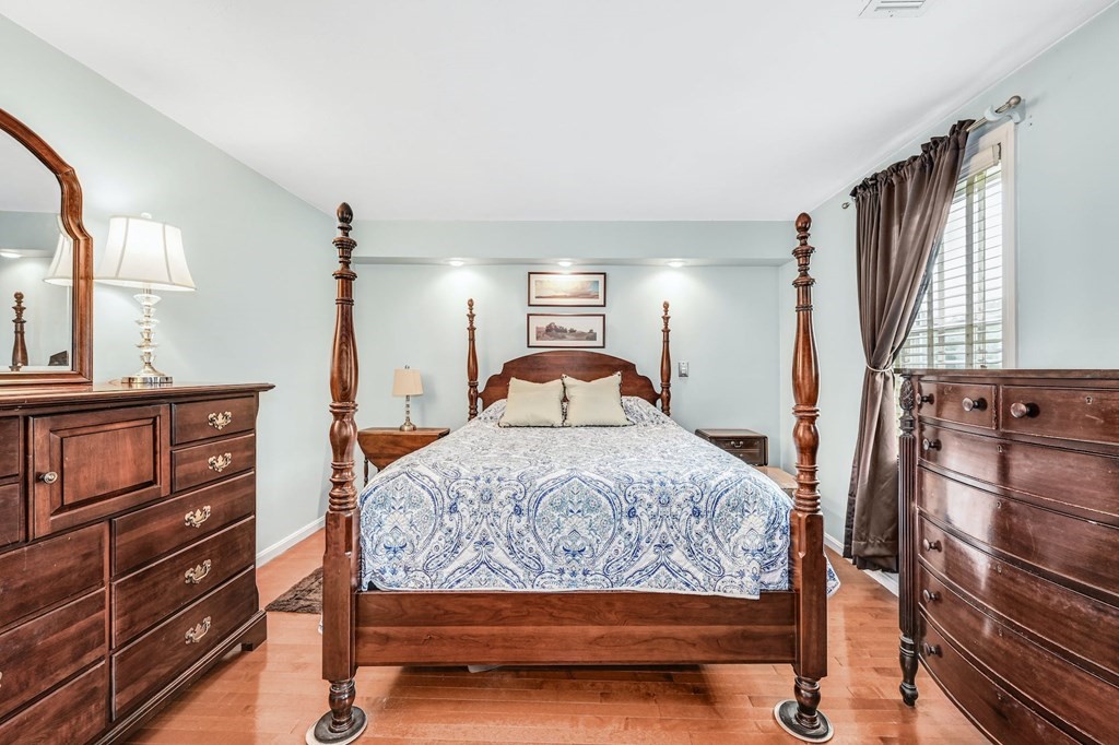 45 Boston Road, Unit C Sutton, MA 01590 - Photo 20 of 35 a bedroom with a bed and wooden floor