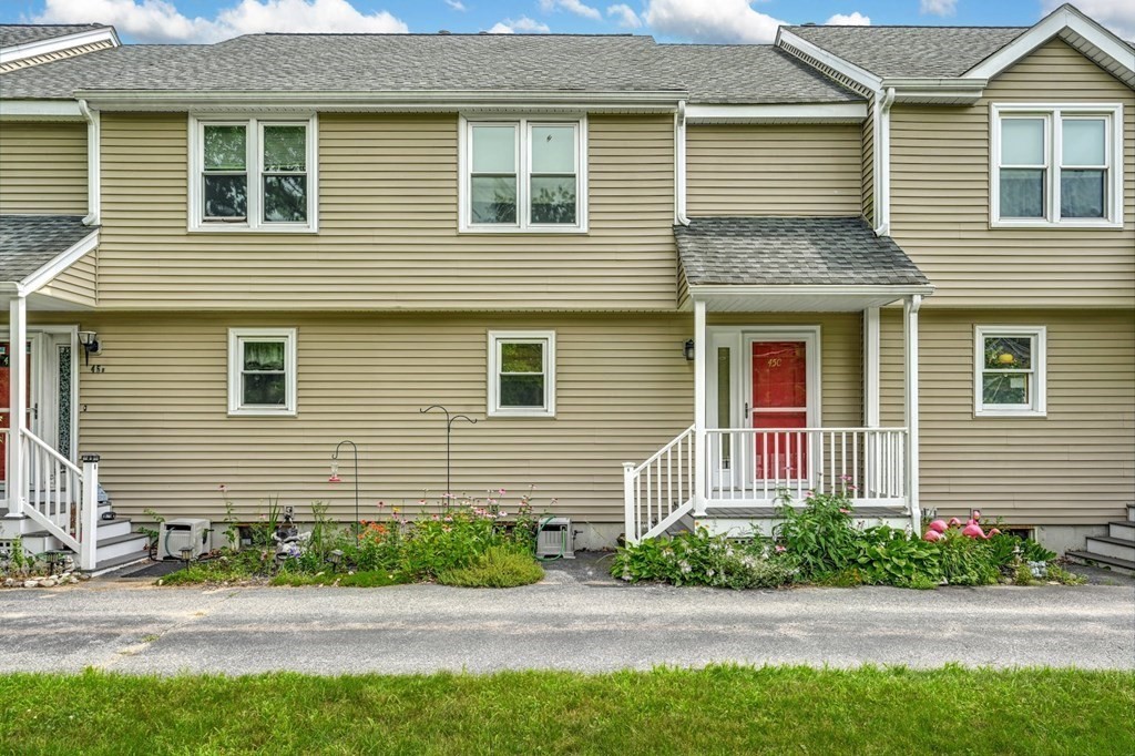 45 Boston Road, Unit C Sutton, MA 01590 - Photo 2 of 35 a front view of a house with a yard and potted plants