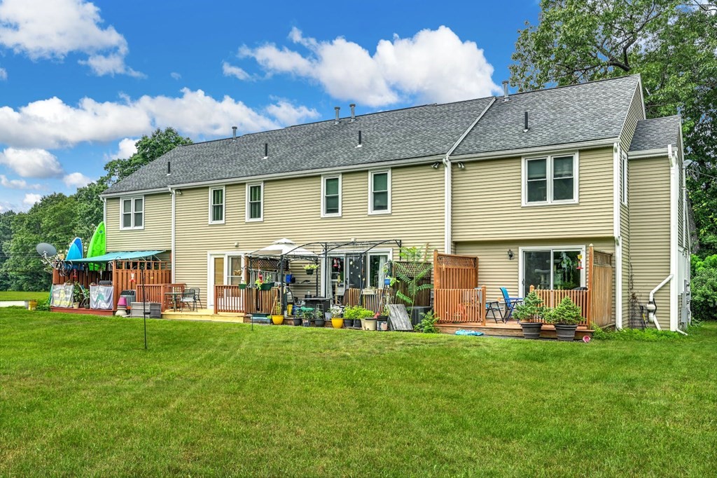 45 Boston Road, Unit C Sutton, MA 01590 - Photo 31 of 35 a front view of house with yard and outdoor seating