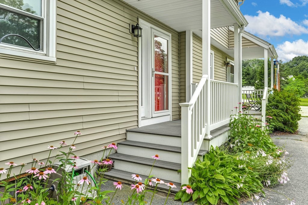 45 Boston Road, Unit C Sutton, MA 01590 - Photo 6 of 35 a view of a house with plants and a porch