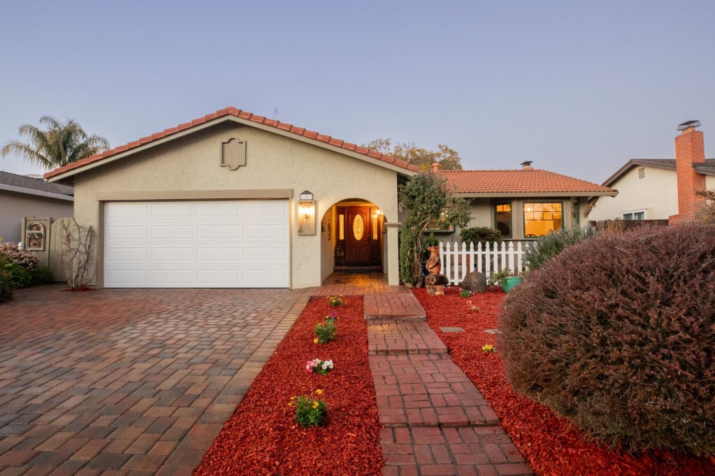1163 Crespi Drive Sunnyvale, CA 94086 - Photo 2 of 49 a front view of a house with a yard and garage