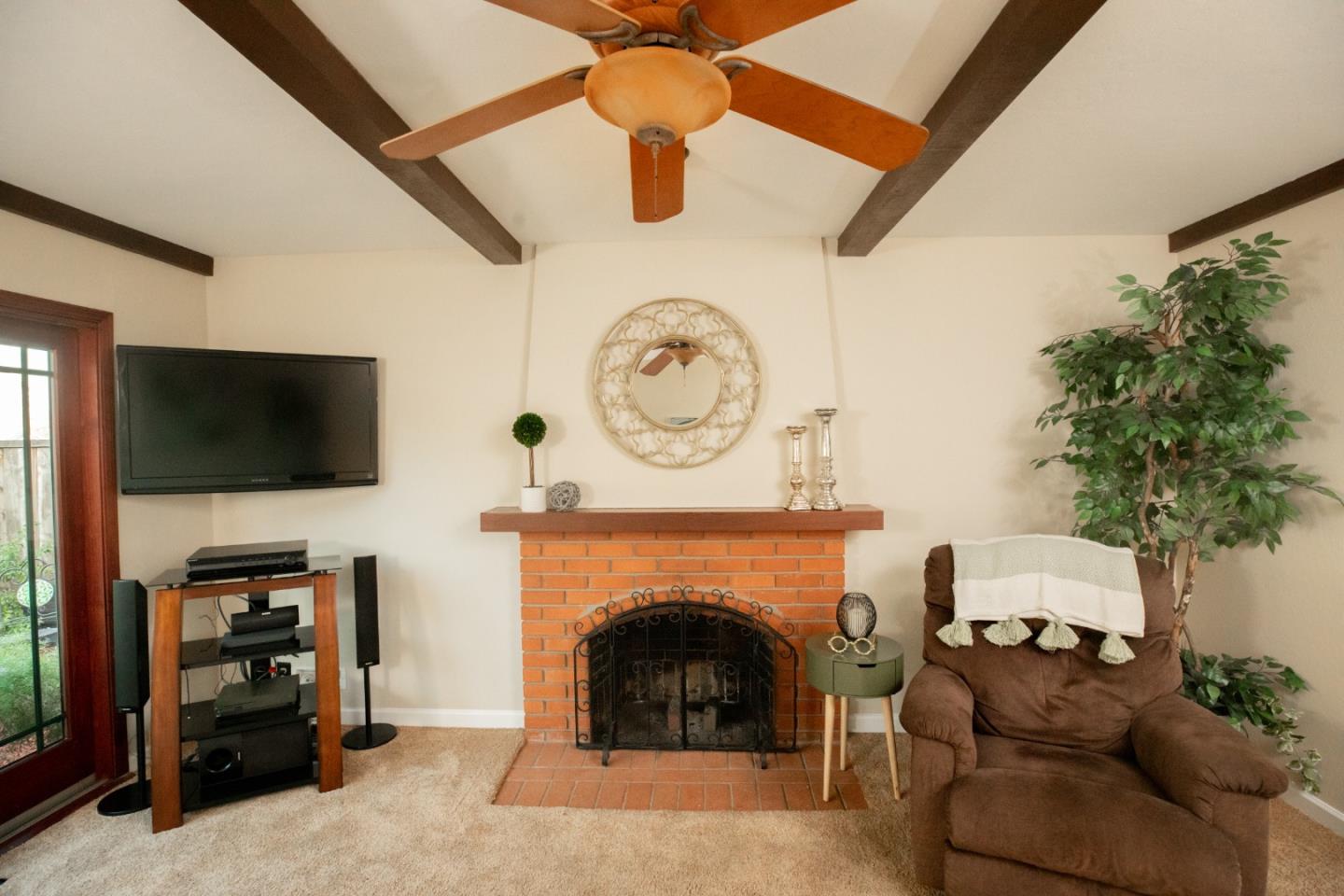 1163 Crespi Drive Sunnyvale, CA 94086 - Photo 22 of 49 a living room with furniture a flat screen tv and a fireplace