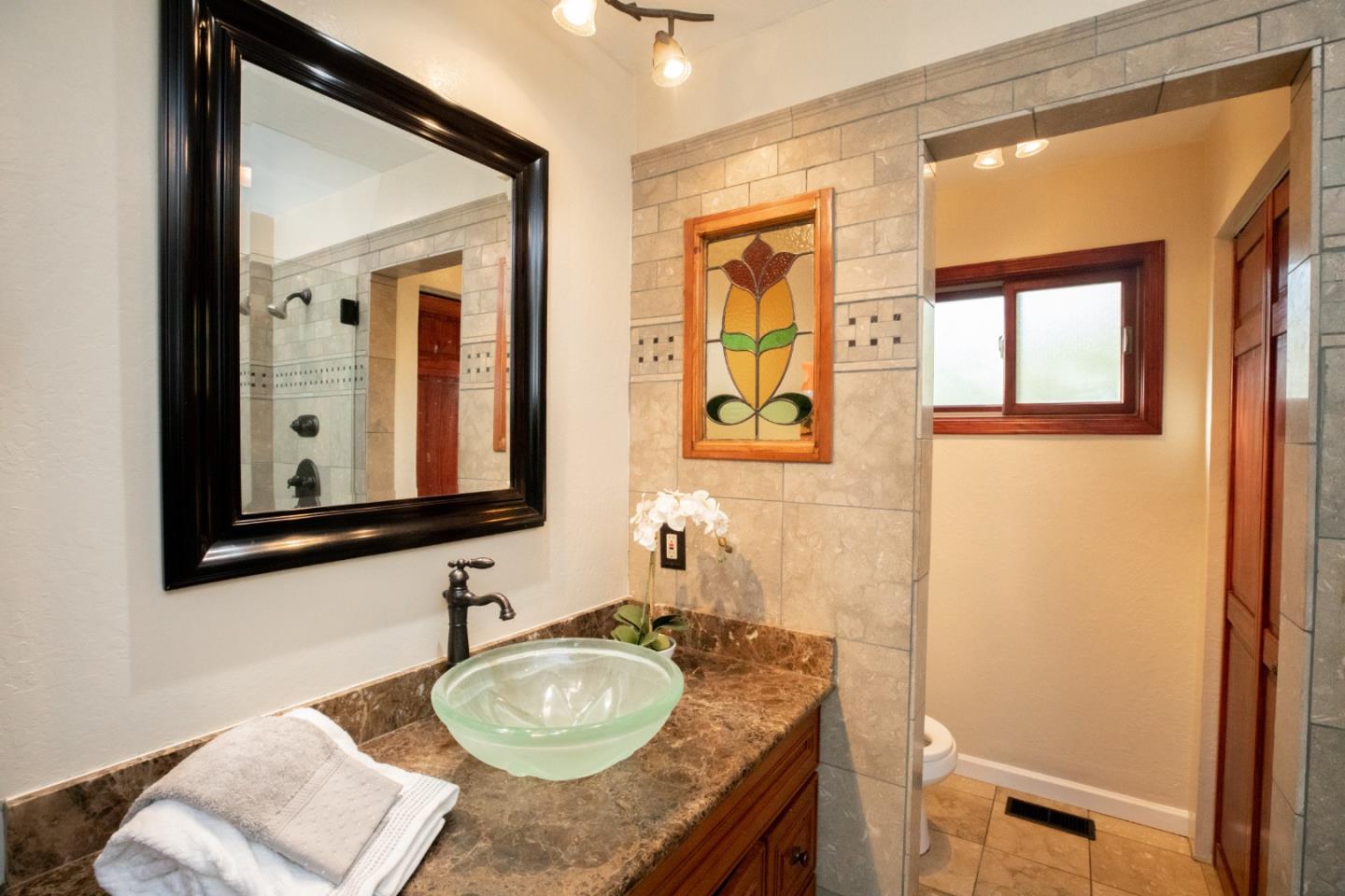 1163 Crespi Drive Sunnyvale, CA 94086 - Photo 39 of 49 a bathroom with a granite countertop sink and a mirror