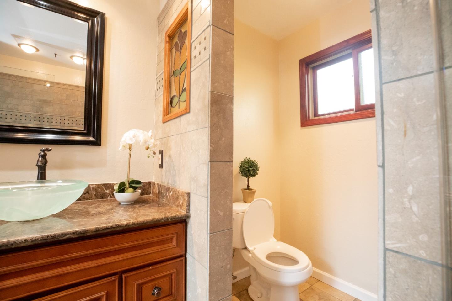 1163 Crespi Drive Sunnyvale, CA 94086 - Photo 40 of 49 a bathroom with a granite countertop toilet sink and mirror