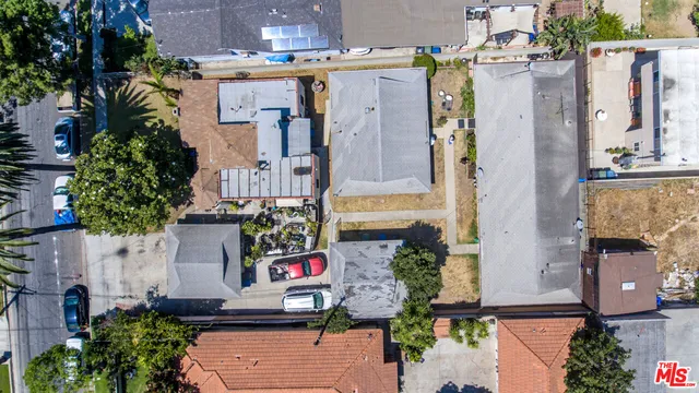 a aerial view of a house with a yard and potted plants
