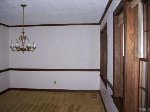 7121 Brecken Ridge Avenue Raleigh, NC 27615 - Photo 6 of 9 Formal Dining room with chair rail and crown Other