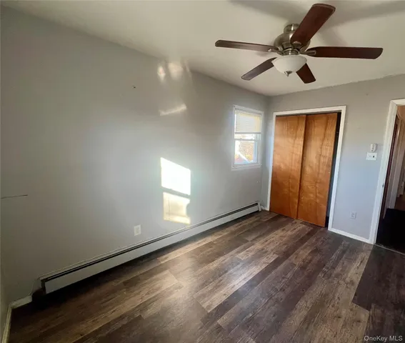 a spacious bathroom with a granite countertop toilet sink and mirror