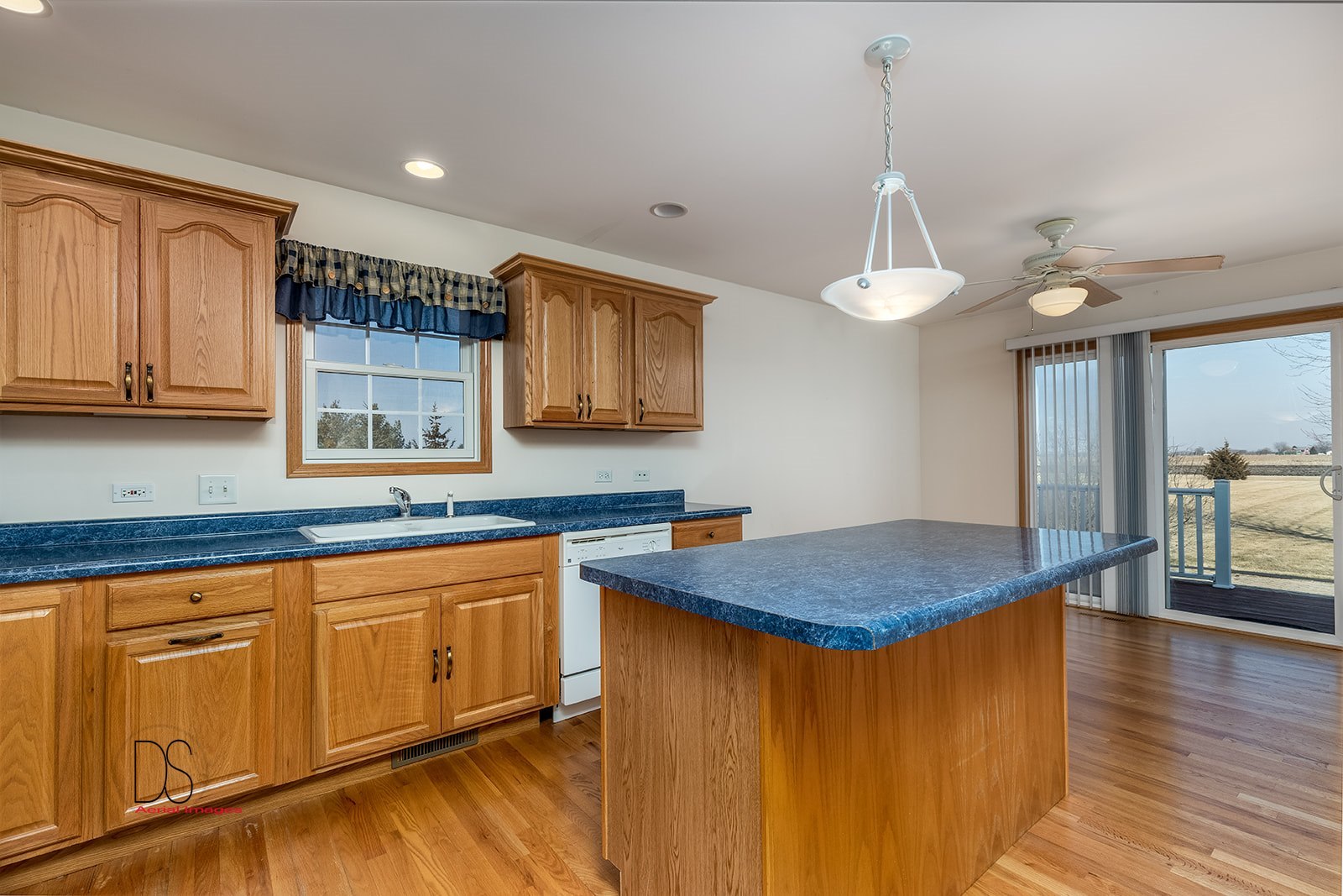 3976 East 2259th Road Serena, IL 60549 - Photo 6 of 24 a kitchen with stainless steel appliances granite countertop a sink dishwasher and microwave with wooden floor