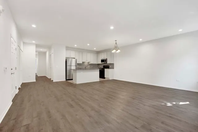 a view of a kitchen with a sink and a refrigerator