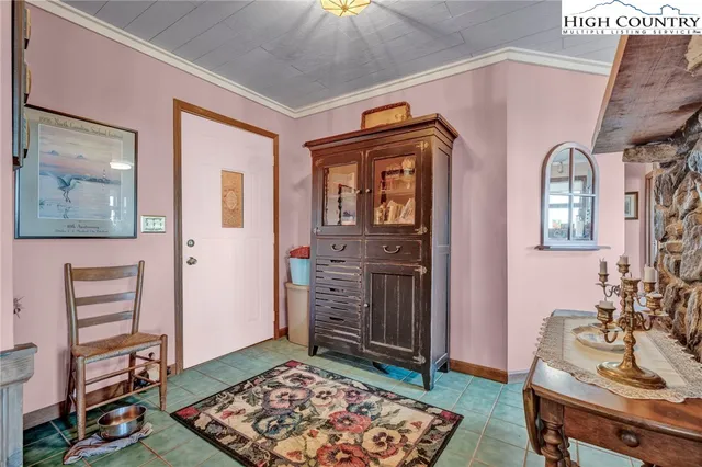 a bedroom with a bed and dresser with mirror