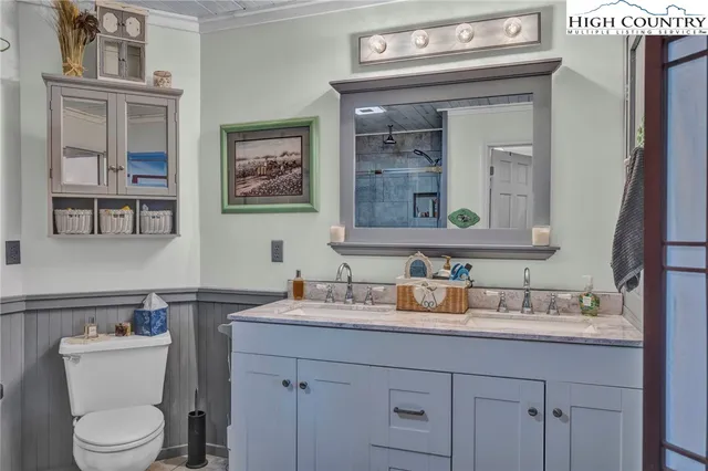 a view of a hallway with wooden walls and door