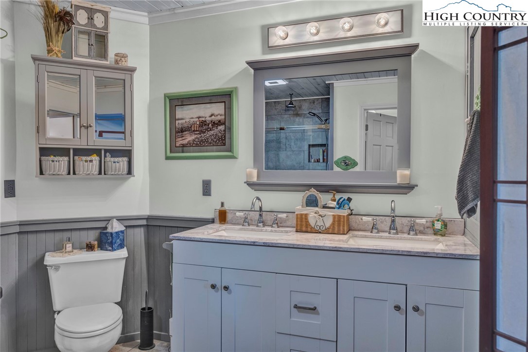 540 Mountain Farm Road Boone, NC 28607 - Photo 26 of 46 a bathroom with a toilet sink and mirror