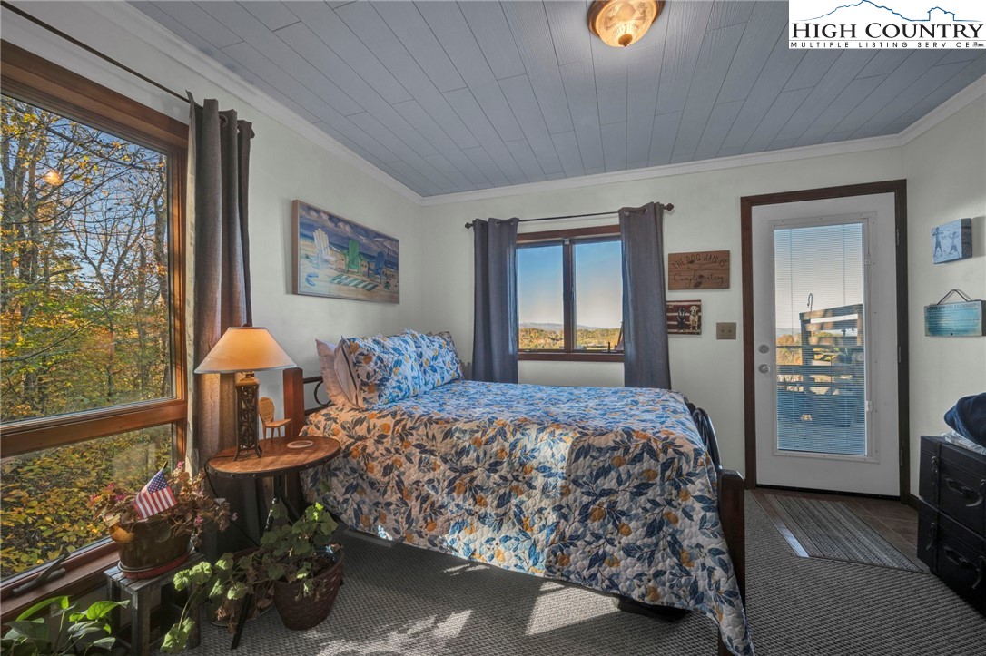 540 Mountain Farm Road Boone, NC 28607 - Photo 28 of 46 a bedroom with a bed and dresser with mirror