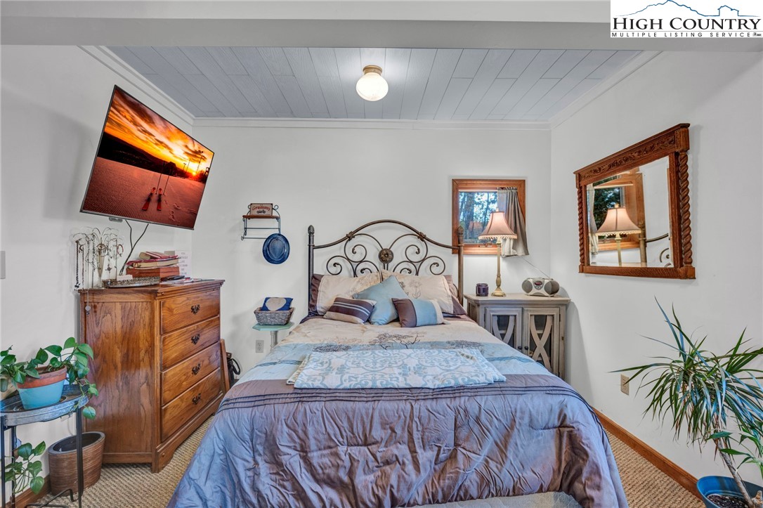 540 Mountain Farm Road Boone, NC 28607 - Photo 29 of 46 a bedroom with furniture and a flat screen tv