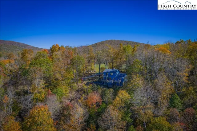 a view of a house with backyard water fountain and sitting area