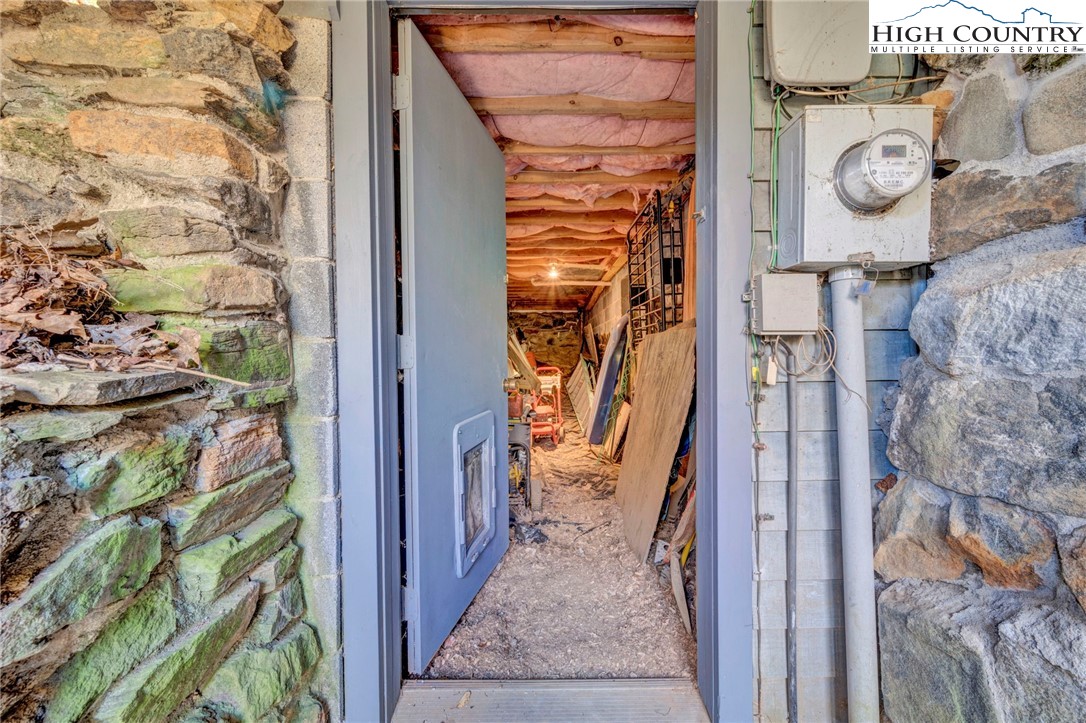 540 Mountain Farm Road Boone, NC 28607 - Photo 44 of 46 a view of a hallway with wooden walls and door