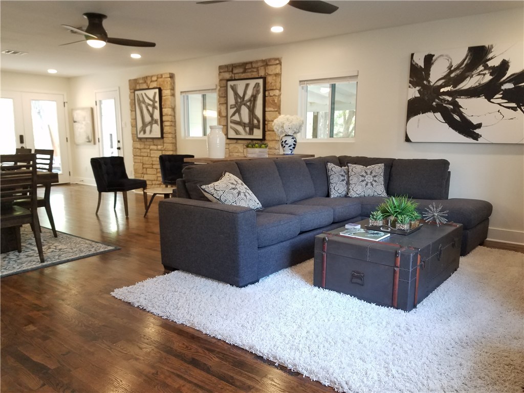 5405 Hudson Street Austin, TX 78721 - Photo 19 of 37 Elegant living area features rich hardwood floors and stylish stone accent walls.