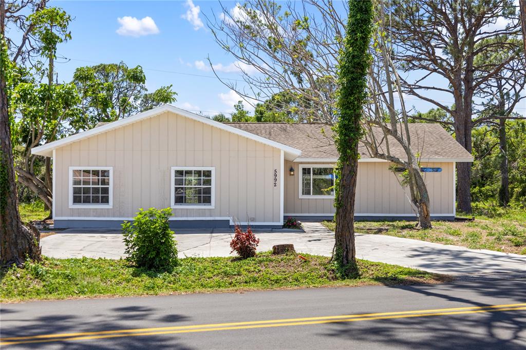 5992 Osprey Road Venice, FL 34293 - Photo 1 of 1 a house that has a tree in front of it