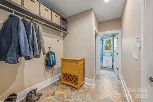 a living room with furniture a rug and a chandelier