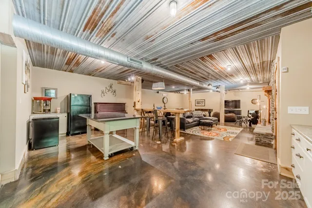 a kitchen with granite countertop a sink stainless steel appliances cabinets and a large window