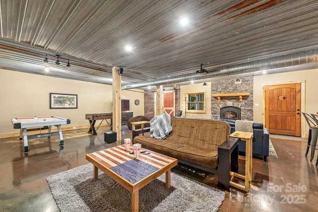 a living room with furniture a flat screen tv and a floor to ceiling window