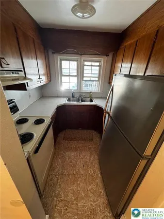 a kitchen with a sink appliances and cabinets