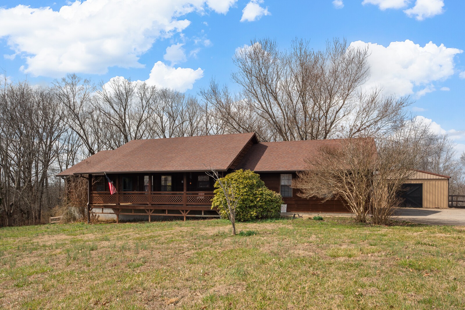 2427 Toler Road Woodlawn, TN 37191 - Photo 1 of 48 a front view of a house with garden