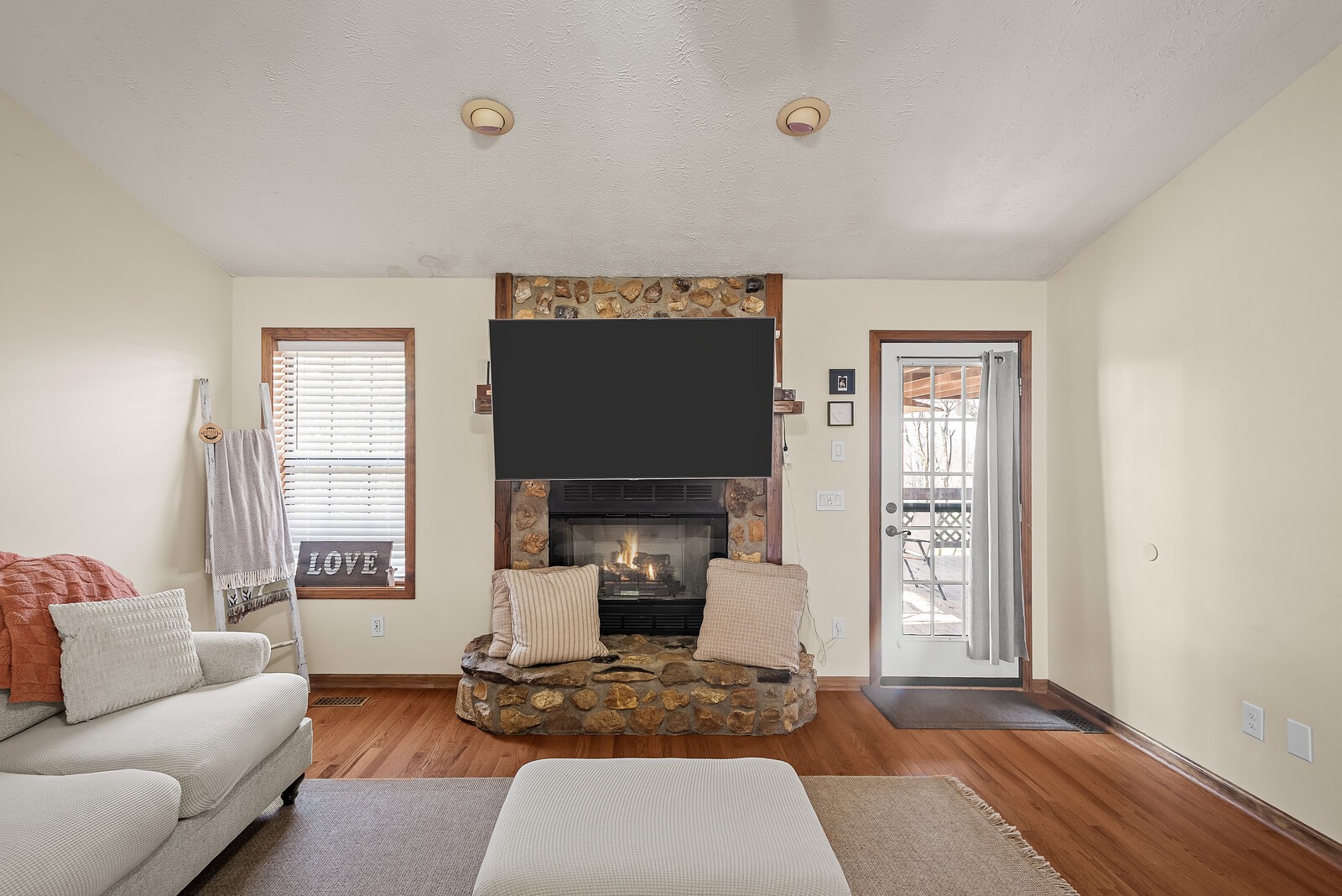 2427 Toler Road Woodlawn, TN 37191 - Photo 11 of 48 a living room with furniture a fireplace and a window