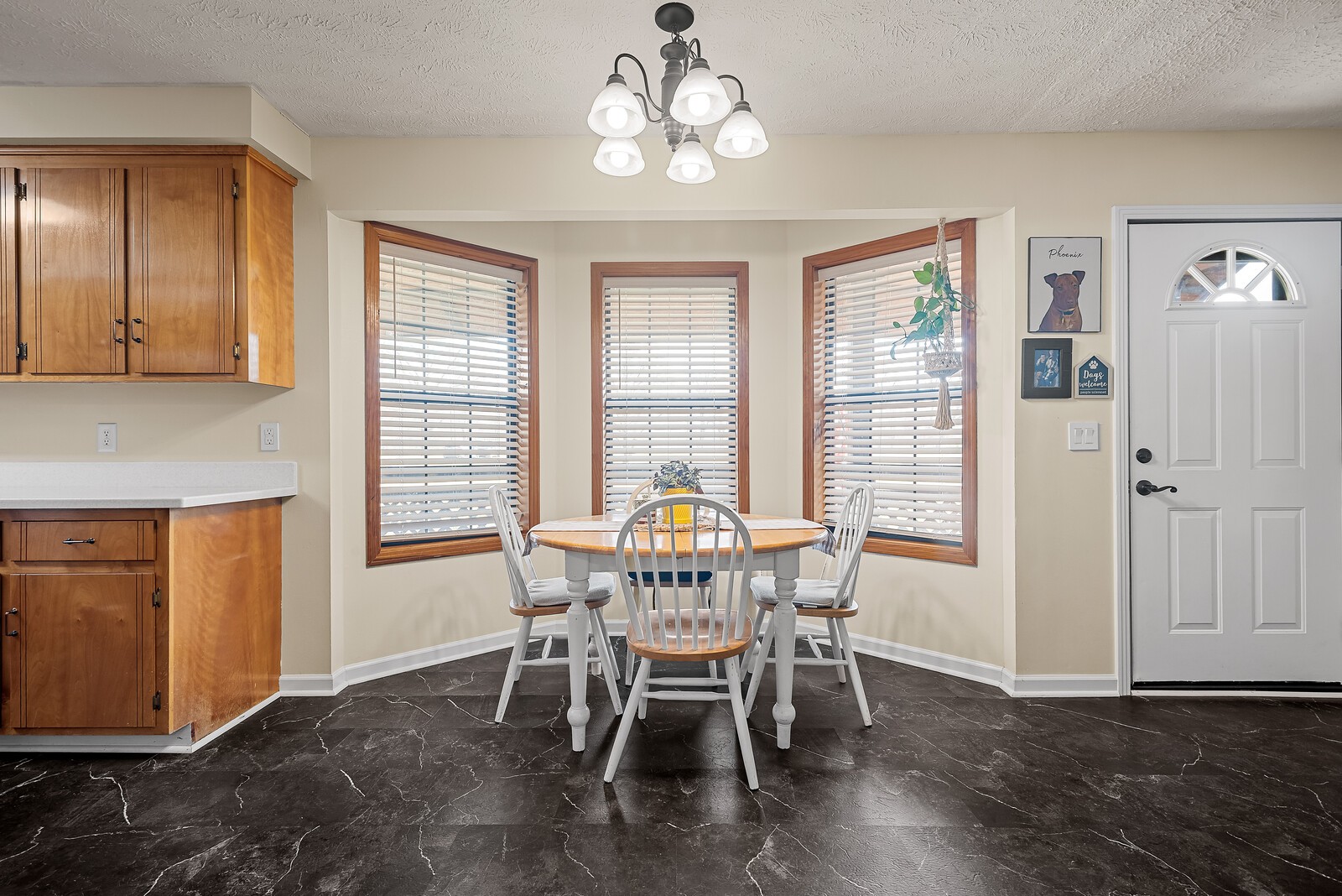 2427 Toler Road Woodlawn, TN 37191 - Photo 16 of 48 a dining room with wooden floor a chandelier a glass table and chairs