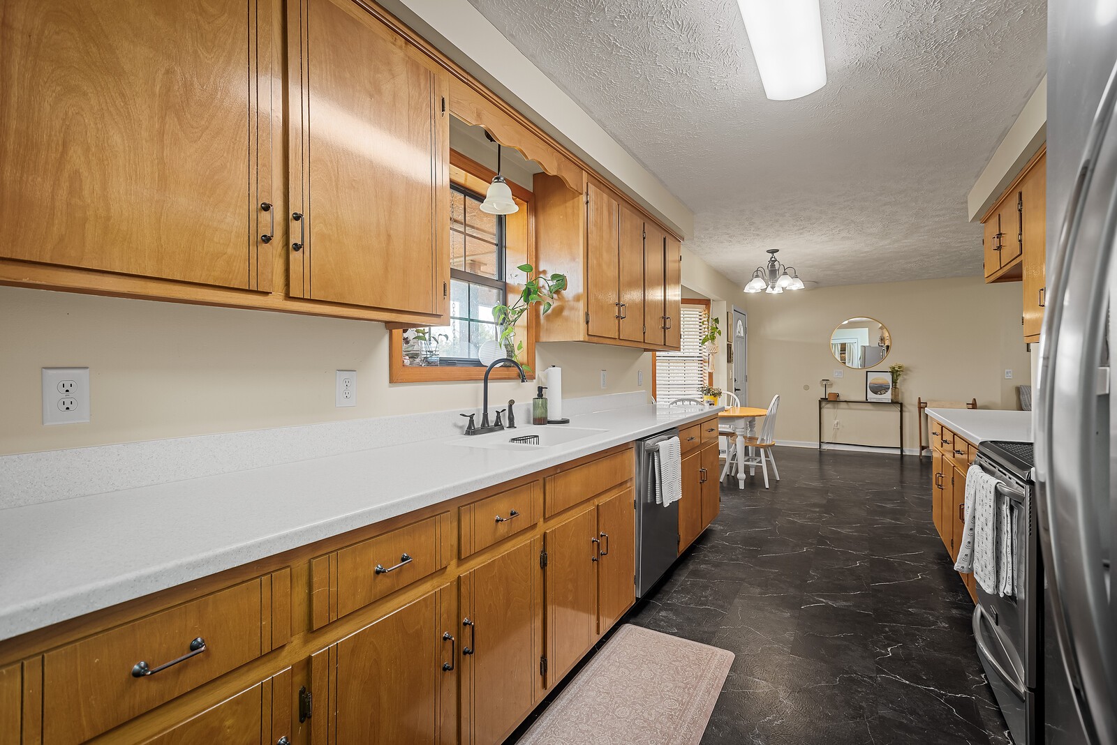 2427 Toler Road Woodlawn, TN 37191 - Photo 20 of 48 a large kitchen with a sink and dishwasher a oven with wooden floors