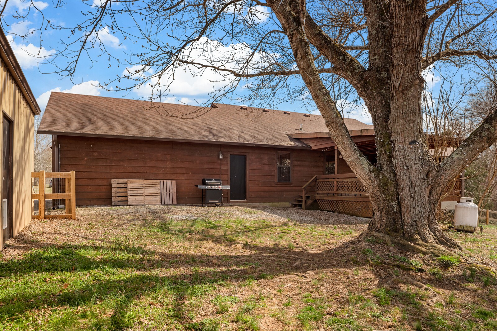 2427 Toler Road Woodlawn, TN 37191 - Photo 39 of 48 a view of a house with a yard tree and wooden fence